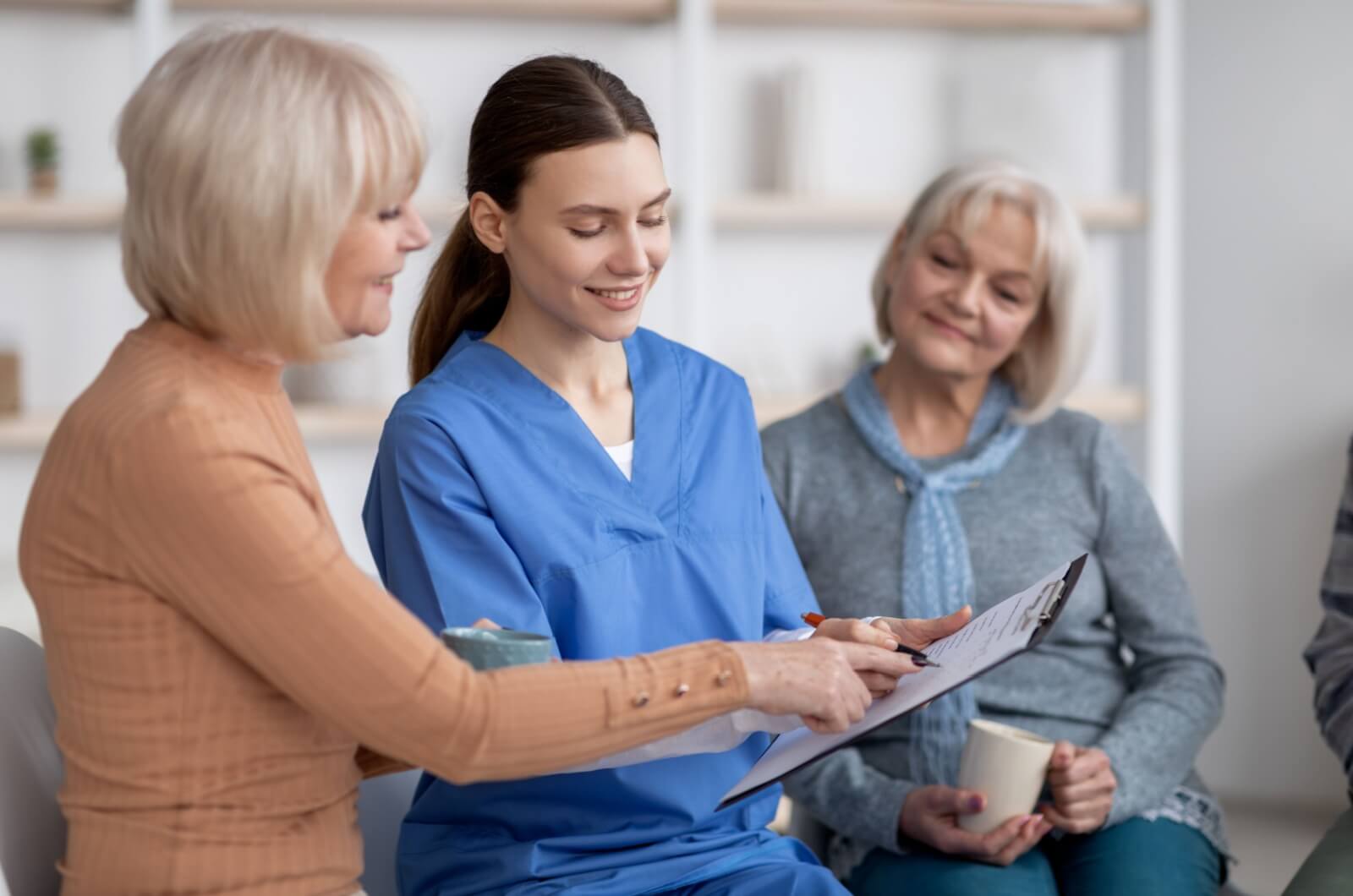 A personal care community staff member providing information to family members of loved ones.